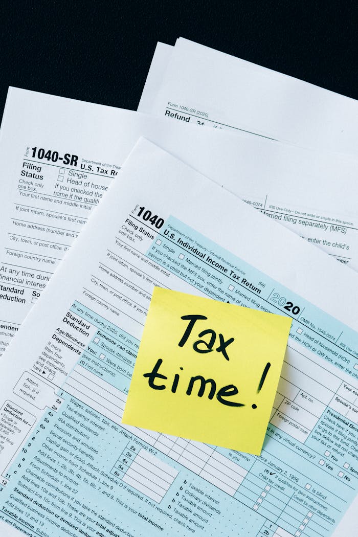IRS 1040 tax forms with handwritten Tax Time! note for filing reminder.
